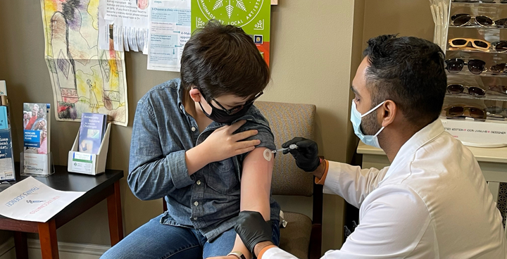 Pharmacist vaccinating a child at Lititz Apothecary