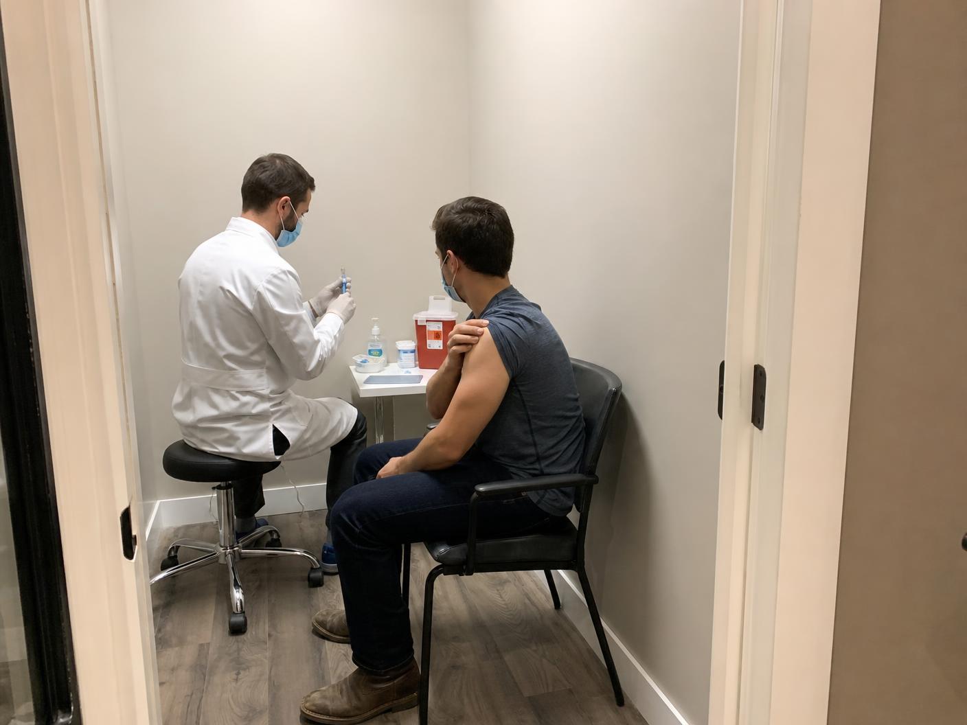 A pharmacist administering a vaccine